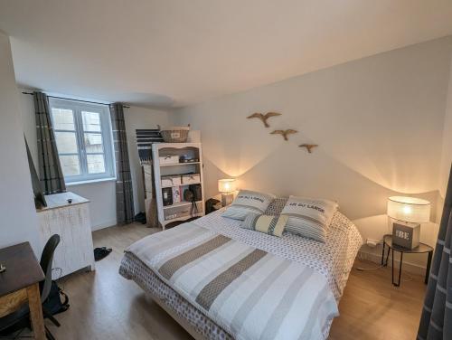 une chambre avec un grand lit et une fenêtre dans l'établissement Appartement lumineux et calme proche mer a pieds, à Saint-Malo