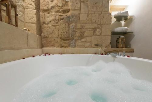 a bath tub filled with snow in a bathroom at Le Nicchie luxury rooms in Lecce