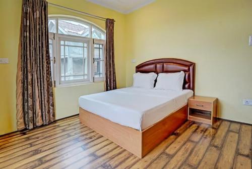 a bedroom with a large bed and a window at Lit Homestay in Srinagar