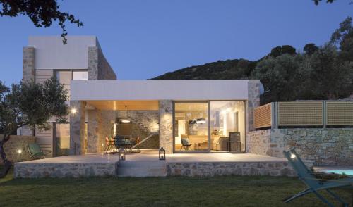 a modern house with a stone wall at Atrium Villas in Kechria