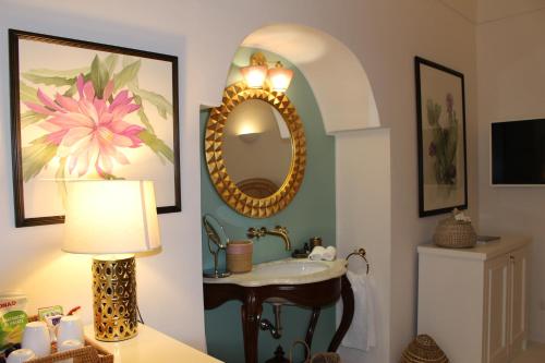 a bathroom with a sink and a mirror at Il Palazzetto Ponza in Ponza