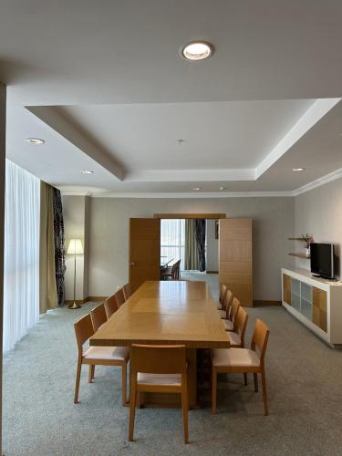 a conference room with a wooden table and chairs at Grand Nur Plaza Hotel in Aktau