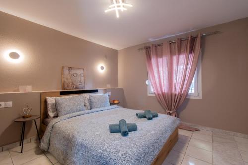 a bedroom with a bed with blue towels on it at Avli Home in Neos Marmaras