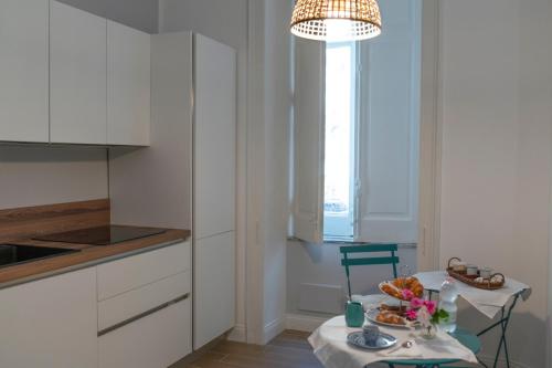 a kitchen with a table with a plate of food on it at Sapore di Sale in Salerno