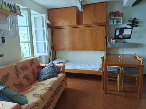a living room with a couch and a desk at La Piccola Barca in Camogli