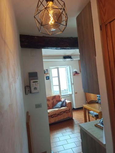 a living room with a couch and a chandelier at La Piccola Barca in Camogli