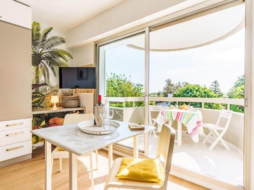 une salle à manger avec une table et des chaises et une grande fenêtre dans l'établissement Studio Super Privé by Interhome, à Biarritz