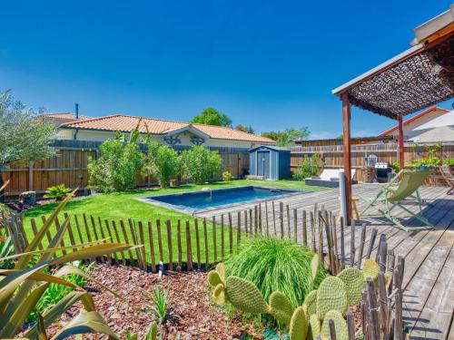 a garden with a swimming pool and cactus at Holiday Home La Cabane Andernosienne by Interhome in Andernos-les-Bains
