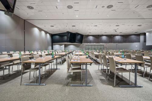 a large dining room with tables and chairs at NH Milano Congress Centre in Assago