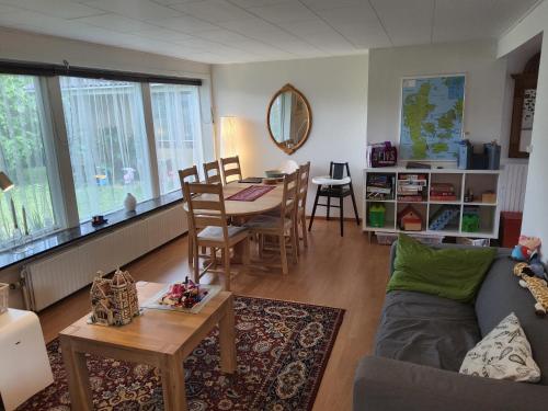 a living room with a couch and a table at Family Friendly Apt B, 900m to Lego House, parking, Legoland, Lalandia in Billund