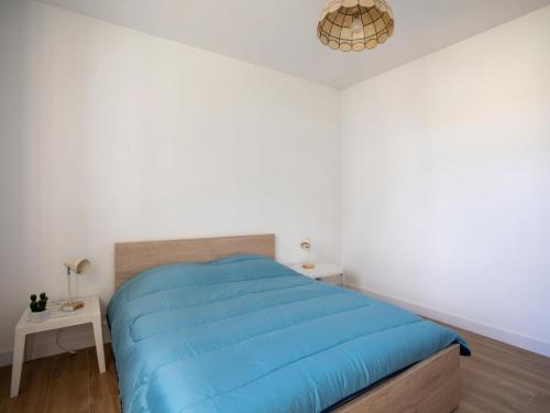 une chambre avec un lit avec une couverture bleue dans l'établissement Apartment le grand large-2 by Interhome, à Cagnes-sur-Mer