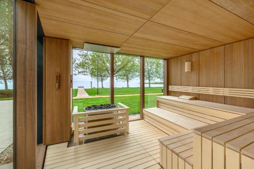an empty sauna with wood paneling and windows at Kenese Bay Garden Resort & Conference in Balatonkenese
