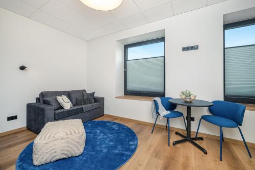 a living room with a couch and a table and chairs at Betooni Stay in Tartu
