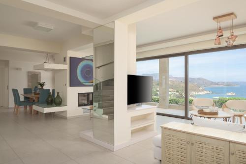 a living room with a view of the ocean at Miraida Exclusive Residence in Almirida