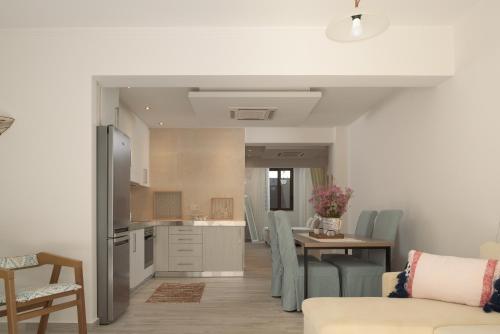 a kitchen and dining room with a table and chairs at Miraida Exclusive Residence in Almirida