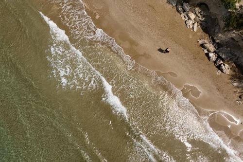 an overhead view of a person swimming on the beach at Miraida Exclusive Residence in Almirida