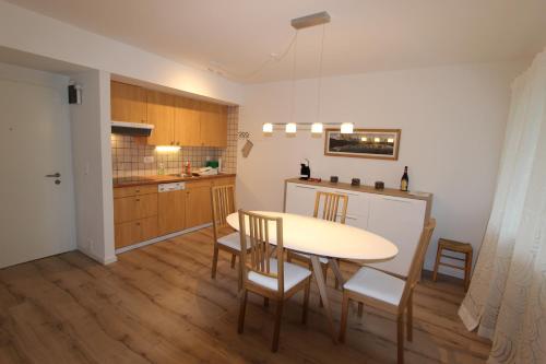 a kitchen and dining room with a table and chairs at Le Castel 1 in Chateau-d'Oex