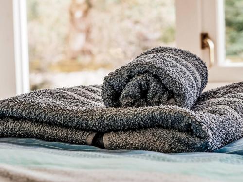 a pile of towels sitting on top of a bed at Holiday Home Old Stables by Interhome in Drumnadrochit
