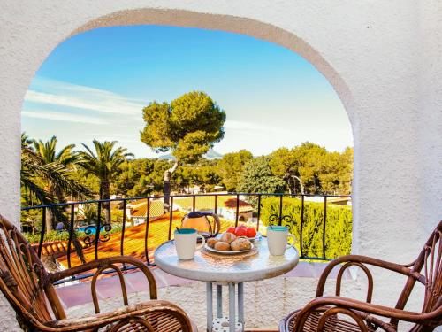 a table with a bowl of fruit on a balcony at Holiday Home Bizet by Interhome in Jávea