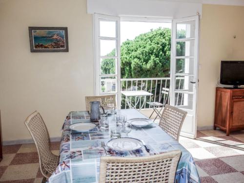 a dining room with a table and chairs at Apartment Les Trois A by Interhome in Saint-Cyr-sur-Mer