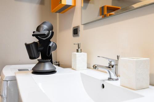a robot head sitting on top of a bathroom sink at Arcave Luxury Apartment in Sirmione