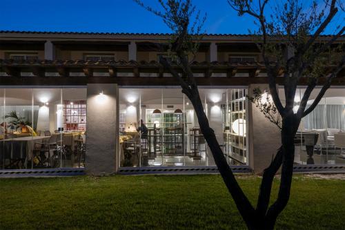 a house with a garden at night at Hotel San Teodoro in San Teodoro