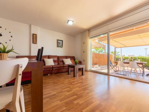 a living room with a couch and a table at Holiday Home Cal 5inc by Interhome in Creixell