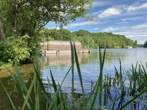 a view of a lake with a wooden dock at Iglu Camp Templin in Templin