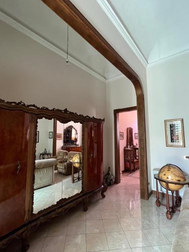 a living room with a large mirror on the wall at Casa nel Liberty in Canicattini Bagni