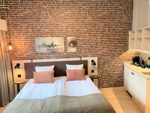 a bedroom with a brick wall and a bed at Skyline Airport Hotel in Vantaa