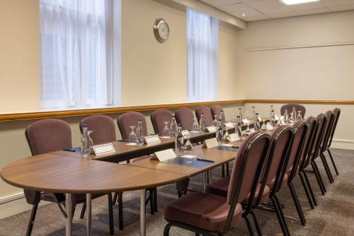 a conference room with a long table and chairs at Hilton Nottingham Hotel in Nottingham