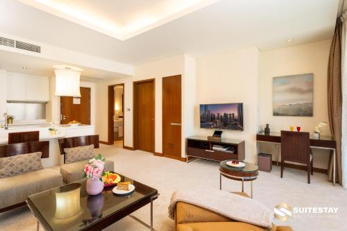 a living room with a couch and a table at Fashion avenue Dubai Mall -The Residence in Dubai