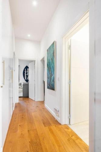 a hallway with white walls and a hard wood floor at Seabreeze Retreat with terrace - St Julians in St Julian's