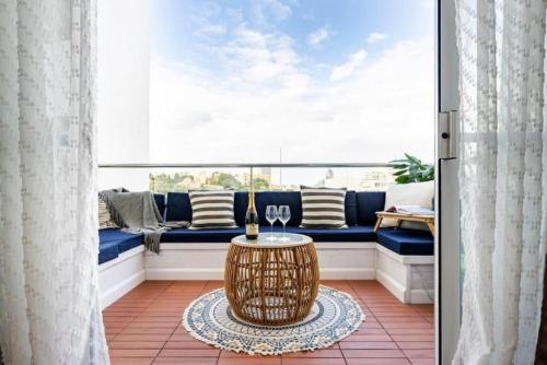 a living room with a couch and a table at Seabreeze Retreat with terrace - St Julians in St Julian's