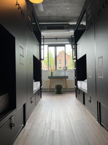 a locker room with two beds and a table at ClinkMama in Amsterdam