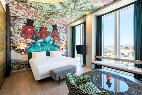 a hotel room with a mural of superheroes at nhow Frankfurt in Frankfurt