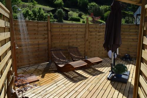 a wooden deck with two chairs and a fountain at Ferienwohnung Baumkrone in Waldeck