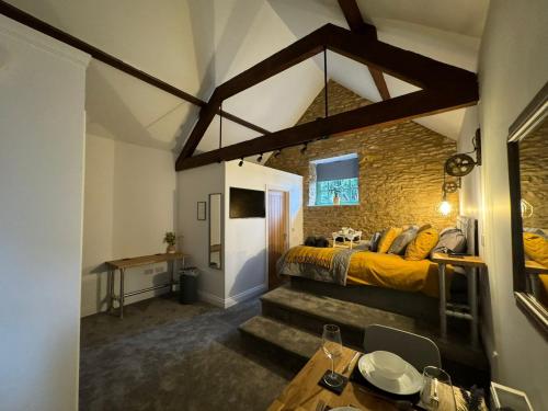 a bedroom with a bed and a brick wall at The Old Stables in Northampton