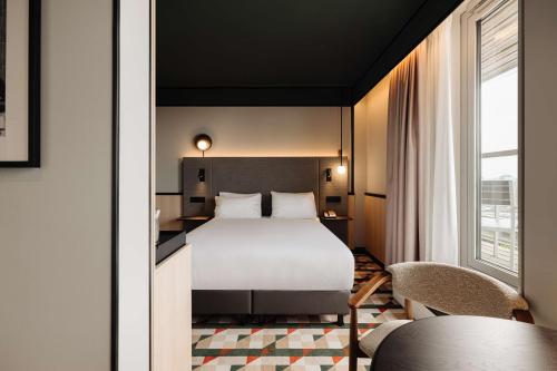 a hotel room with a bed and a table at DoubleTree by Hilton Amsterdam Centraal Station in Amsterdam