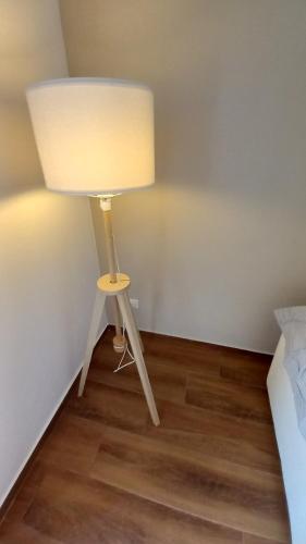a lamp in a corner of a room with a bed at A casa di Edo in Acireale