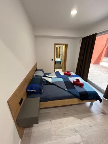 a bedroom with a large bed in a room at Hostelum in Umag