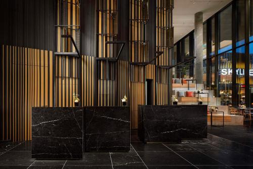 a lobby with two black benches in a building at NH Collection Frankfurt Spin Tower in Frankfurt/Main