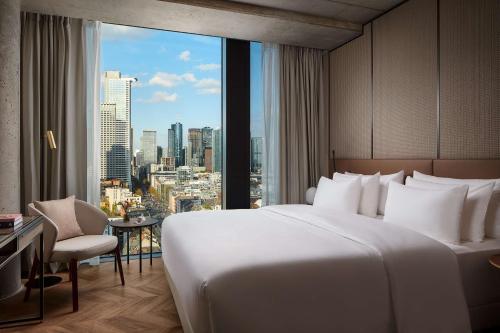 a hotel room with a large bed and a window at NH Collection Frankfurt Spin Tower in Frankfurt/Main