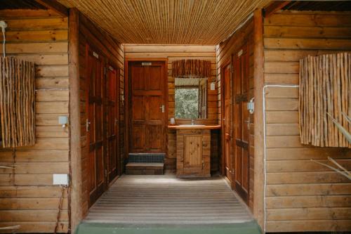an inside view of a cabin with wooden walls at Firefly Falls in Plettenberg Bay