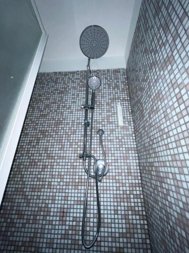 a shower in a bathroom with a tiled floor at Scalo 71 GUEST HOUSE in Rome