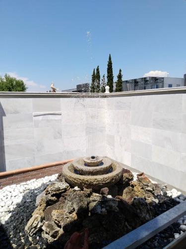 a fountain on the roof of a building at Harmony Sophie's in Néon Rýsion