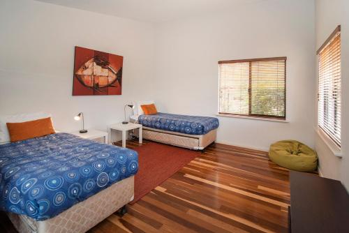 a room with two beds and a window at Cape Illawarra Holiday House Margaret River in Margaret River Town