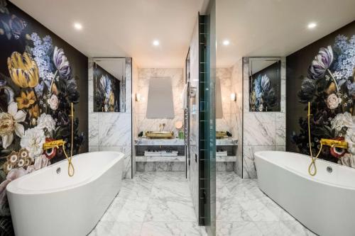 a bathroom with two sinks and two soaking tubs at nhow London in London