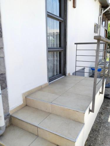 a set of stairs leading to a window on a house at Harmony Sophie's in Néon Rýsion