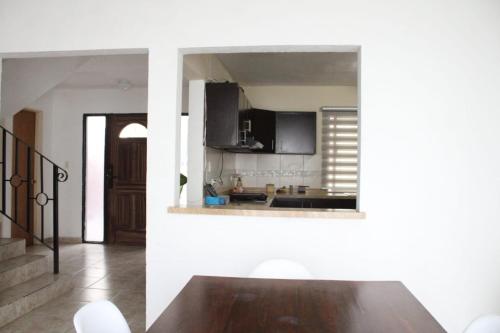 a dining room with a table and a kitchen at Amplia Casa en Sector Viñedos (factura) in Torreón